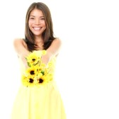 9360260-woman-smiling-showing-yellow-flowers-isolated-on-white-background-beautiful-fresh-young-mixed-race-a